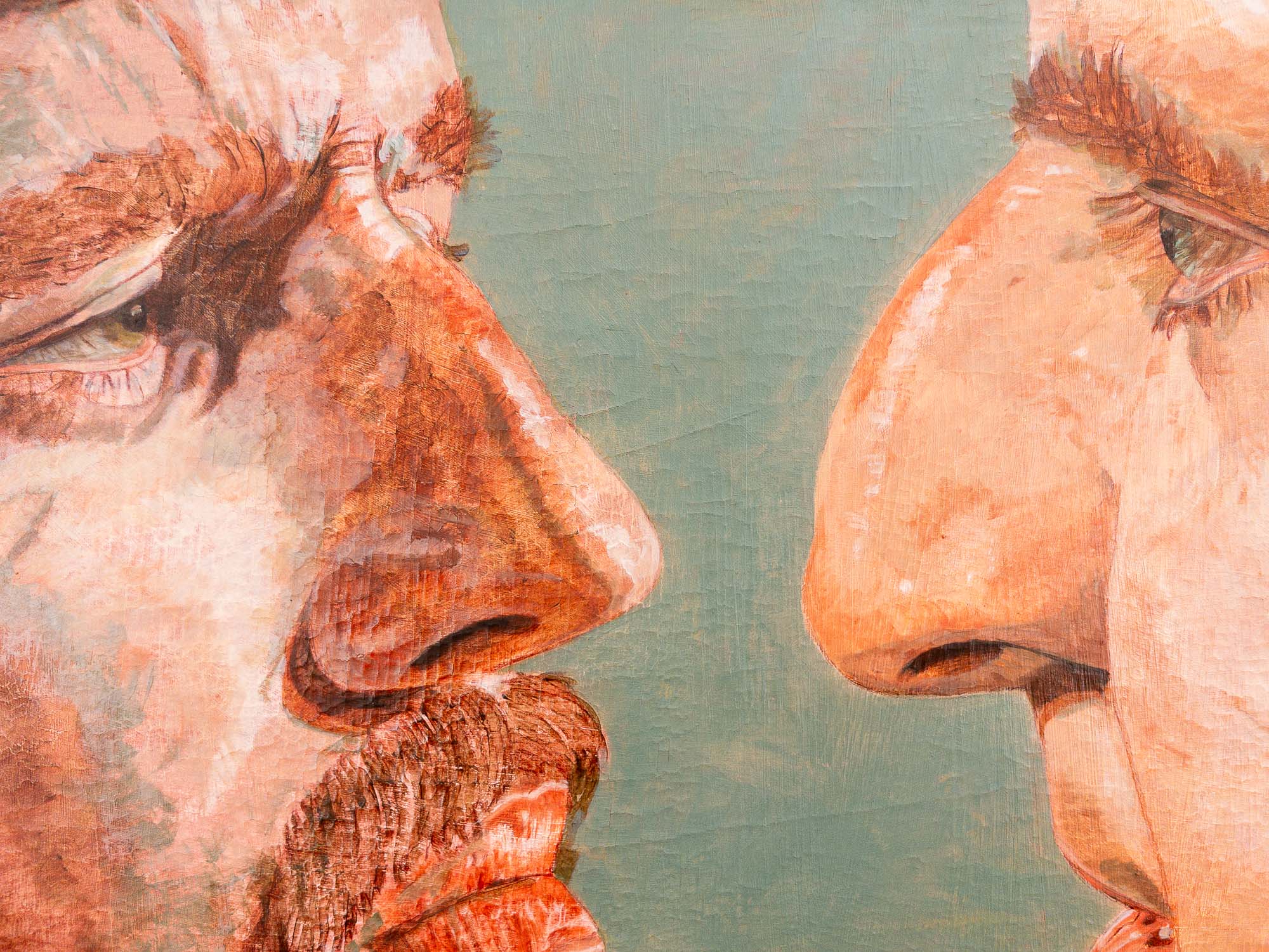 Painting of two faces looking closely at one another.